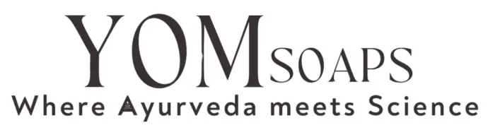 The image features the YOM Soaps logo with a clean, modern font and a lotus icon, accompanied by the tagline “Where Ayurveda meets Science.” The monochromatic design reflects a fusion of tradition and innovation, perfect for a wellness-focused brand. 🌿🔬